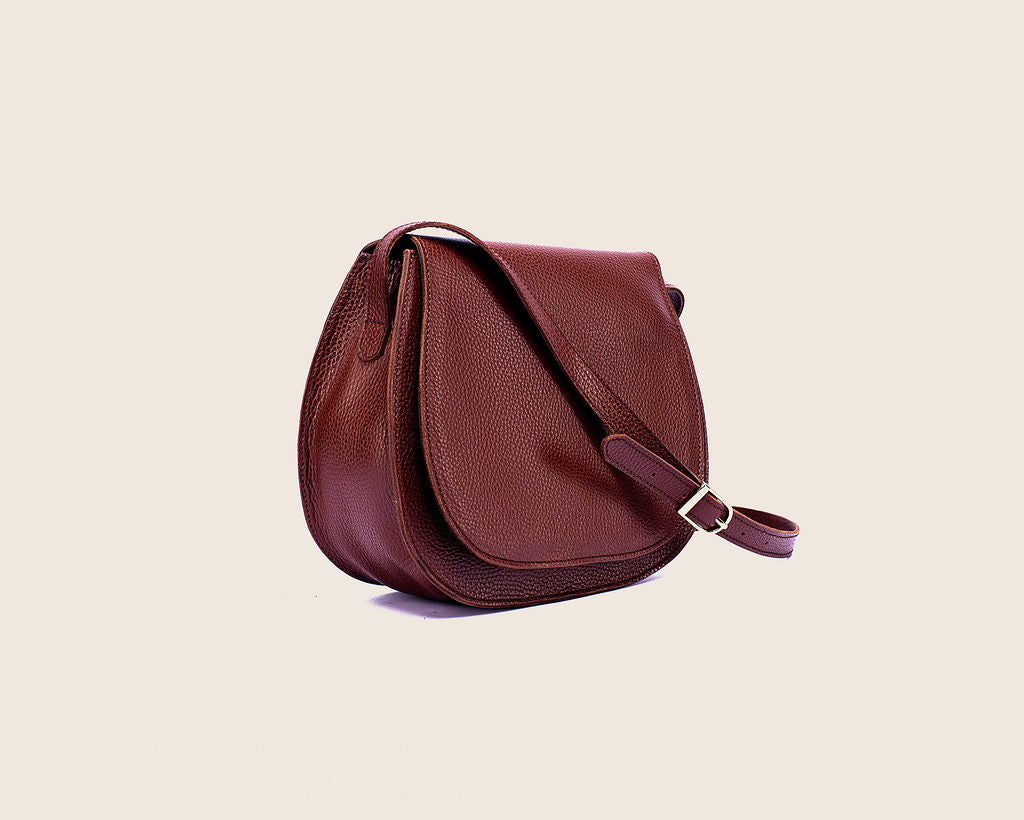 Saddle crossbody in Firebrick milled leather with a crossbody strap