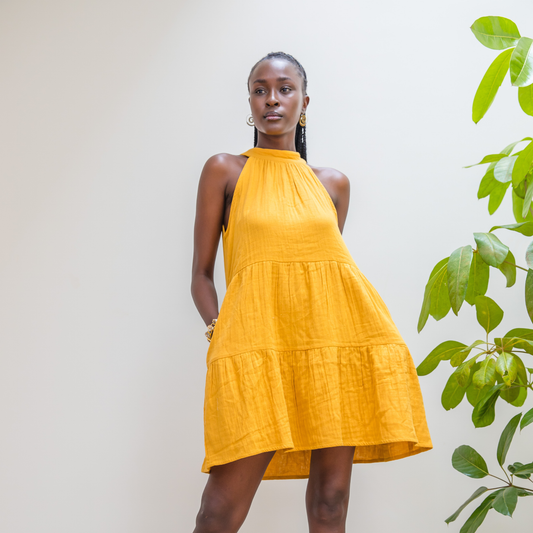 Golden Dusk Jua halter dress featuring adjustable back tie in breathable double cheesecloth.
