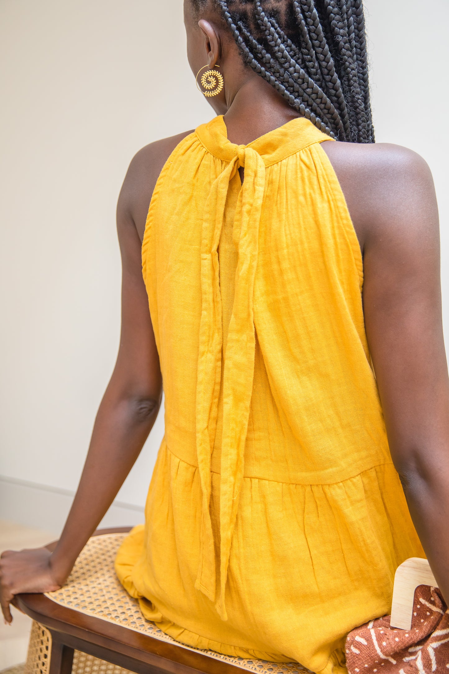 Golden Dusk Jua halter dress featuring adjustable back tie in breathable double cheesecloth.