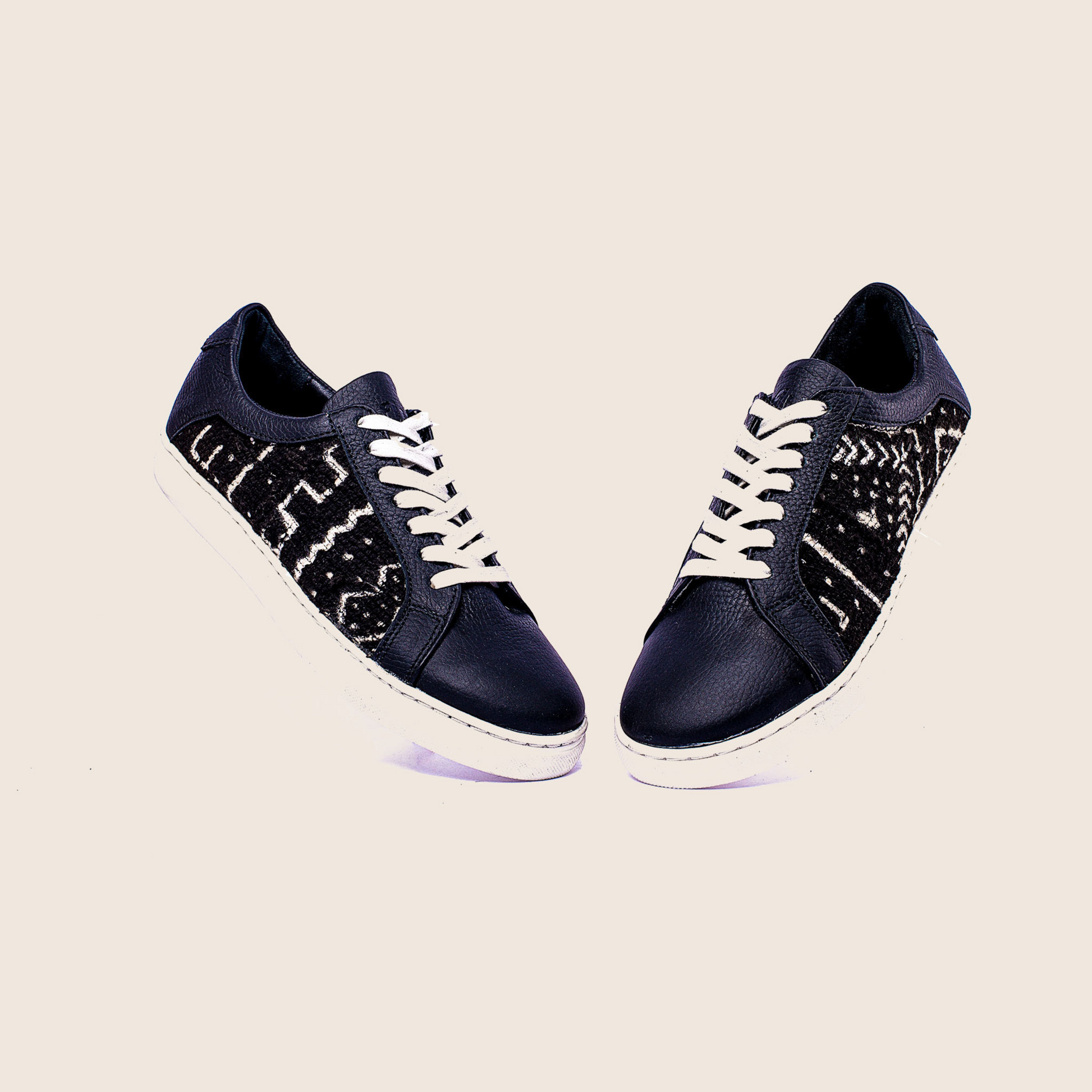 Lowtop mudcloth sneaker in black milled leather and royal soles.